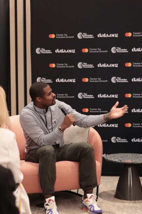 Mastercard Impact Data Summit - speaker talking on stage about AI for sustainability